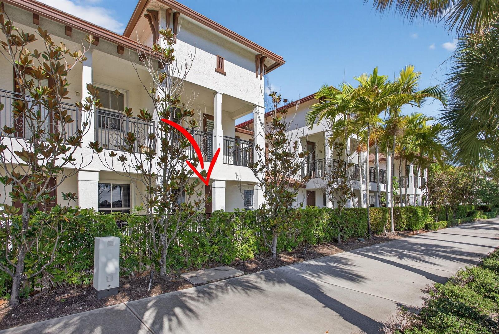A two-story residential building with balconies, a hedge, and a sidewalk under a blue sky — 4718 Monarch Way, Coconut Creek FL 33073, COCONUT CREEK, FL