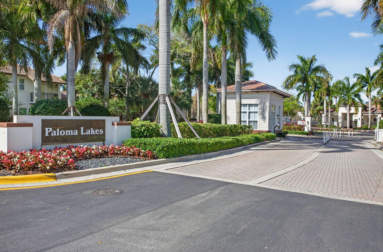 The entrance to the Paloma Lakes community features a sign, palm trees, and a guardhouse — 4718 Monarch Way, Coconut Creek FL 33073, COCONUT CREEK, FL