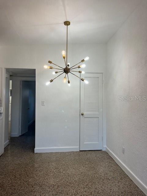 A room with a sputnik chandelier, a louvered door, and speckled flooring — 1434 MINNESOTA AVENUE, WINTER PARK, FL