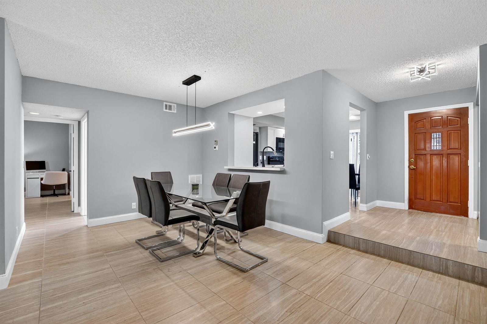 A dining area with a glass table, modern chairs, and tile flooring near an entryway — 7773 La Mirada Drive, Boca Raton FL 33433, BOCA RATON, FL