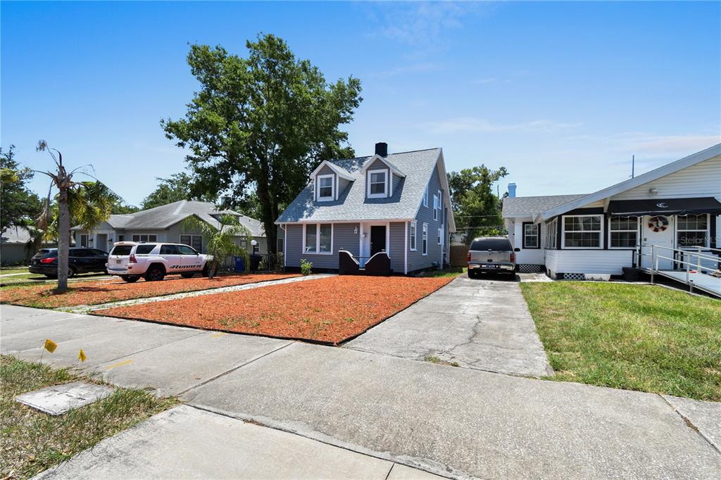 A gray two-story house with a front yard covered in red mulch and a driveway — 766 13TH AVENUE S, ST PETERSBURG, FL