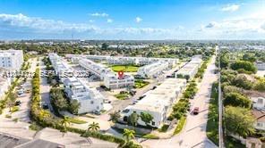 An aerial view shows a residential complex with multiple white buildings and surrounding green spaces — HOMESTEAD, FL
