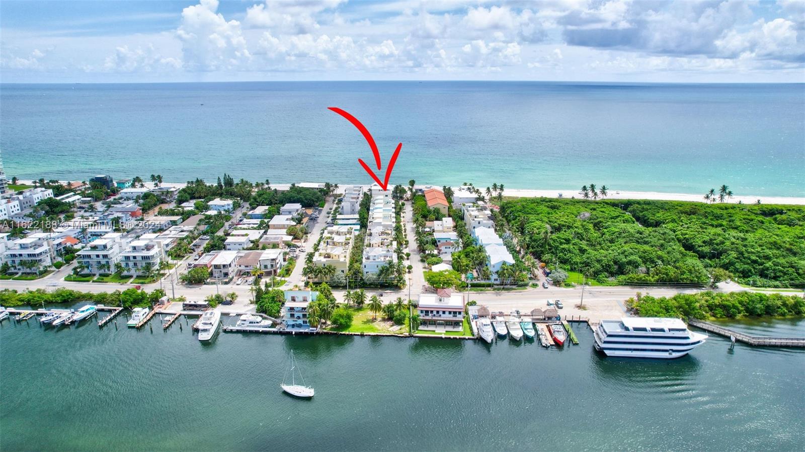 An aerial view shows a row of townhouses situated between a waterway and the ocean — 305 Oak St, Hollywood FL 33019, HOLLYWOOD, FL
