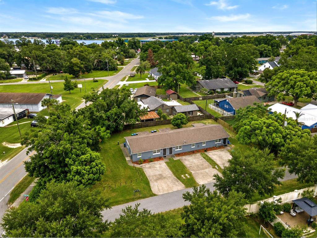 An aerial view shows a gray duplex with a brown roof and concrete parking pads — 5214 JOSEPHINE STREET, ORLANDO, FL