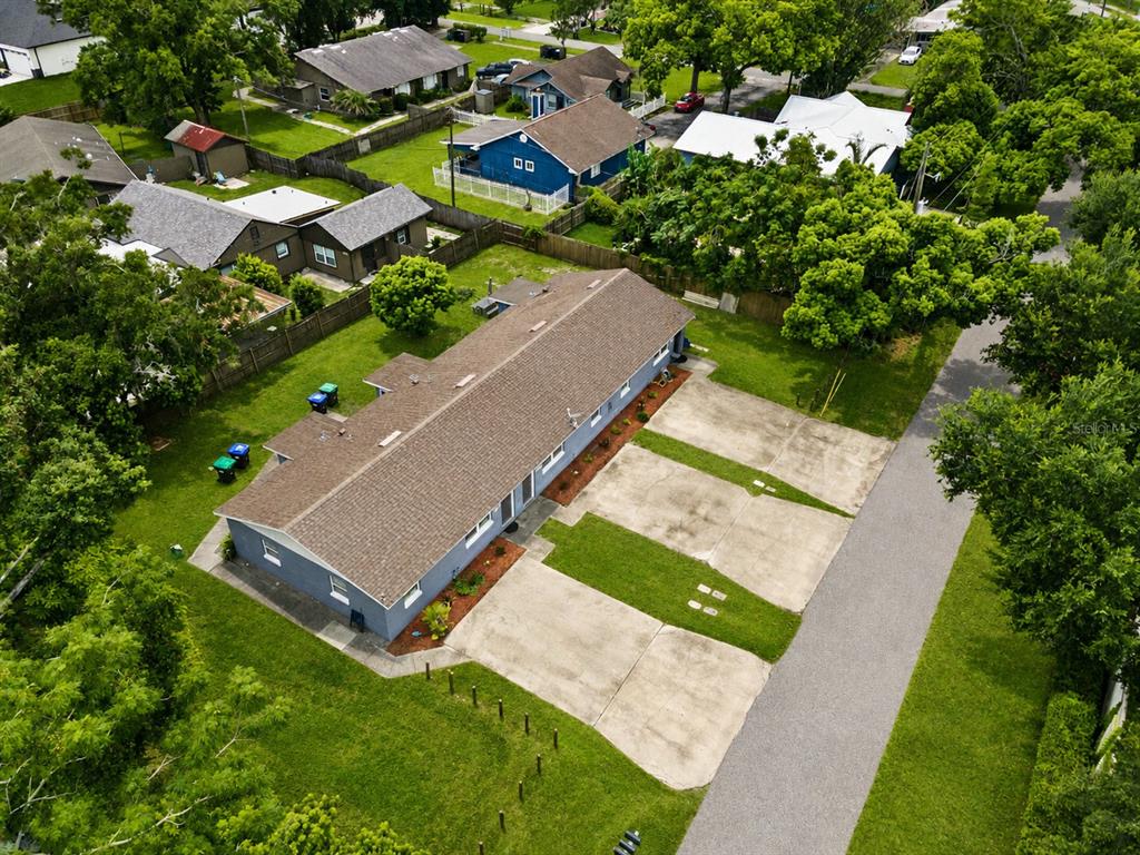 An aerial view shows a blue multi-unit building with a brown roof and concrete parking — 5214 JOSEPHINE STREET, ORLANDO, FL