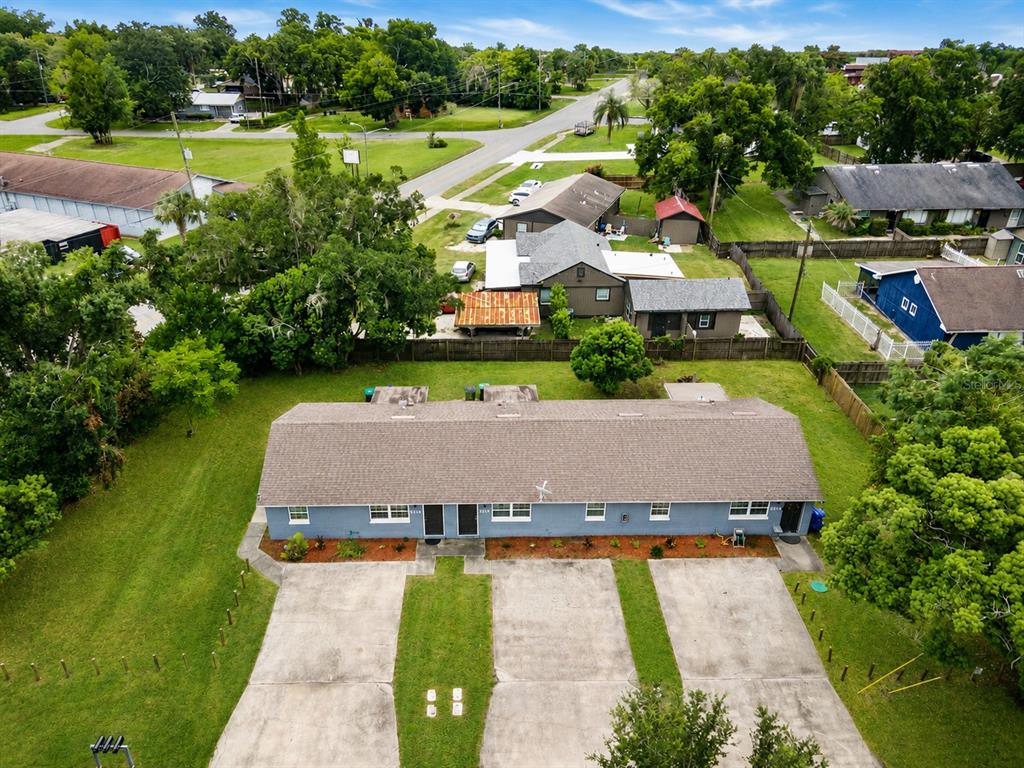An aerial view of a single-story duplex with a gray roof and concrete parking pads — 5214 JOSEPHINE STREET, ORLANDO, FL