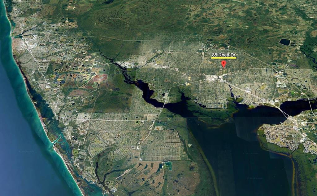 This is an aerial map view showing a residential location marked with a red pin — 88 RHETT DRIVE, PORT CHARLOTTE, FL