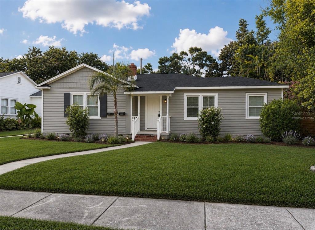 A gray, single-story house with a white front door, black roof, and a manicured lawn — 3601 6TH AVENUE N, ST PETERSBURG, FL