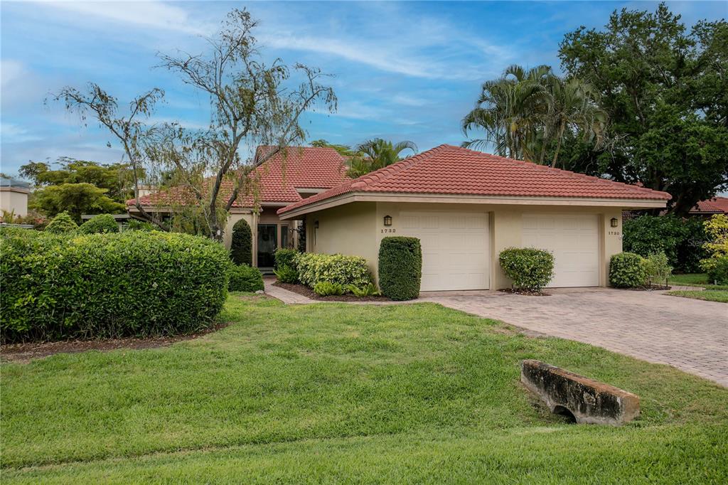A single-story house with a red tile roof and a two-car garage — 1732 KESTRAL PARK WAY S UNIT 43, SARASOTA, FL