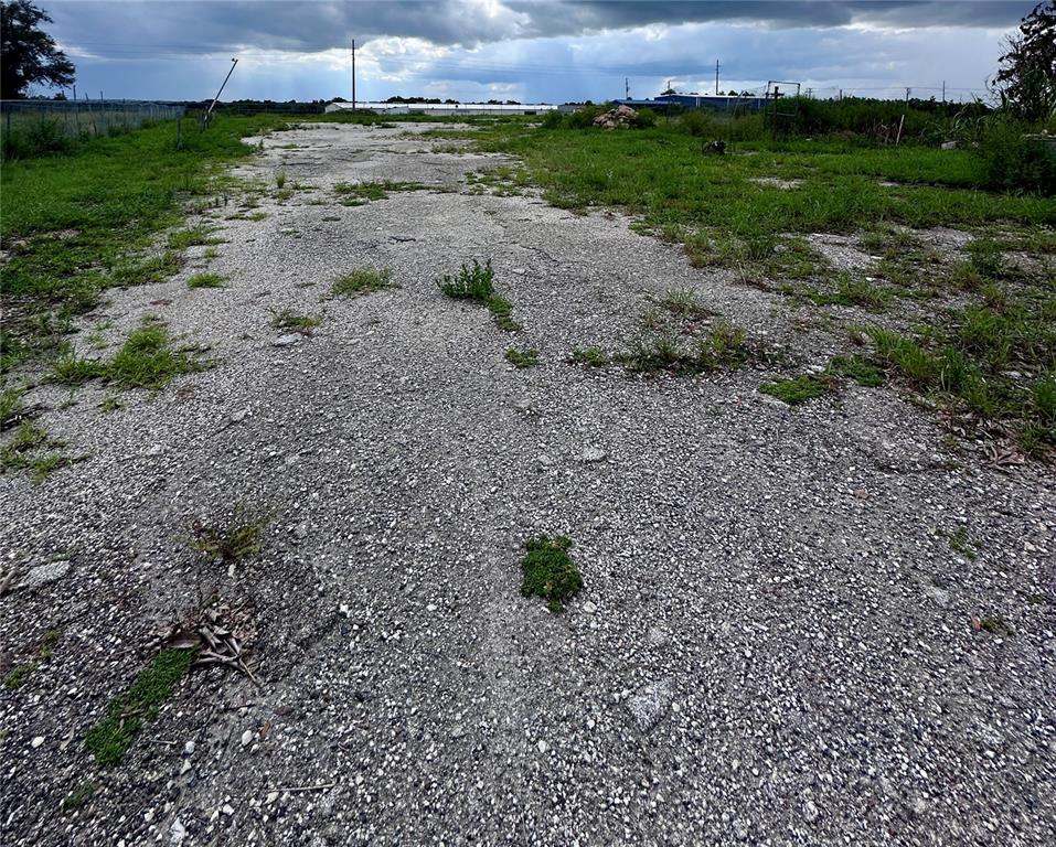 A gravel and dirt lot with patches of grass under a cloudy sky — 802 SCENIC HIGHWAY N, LAKE HAMILTON, FL