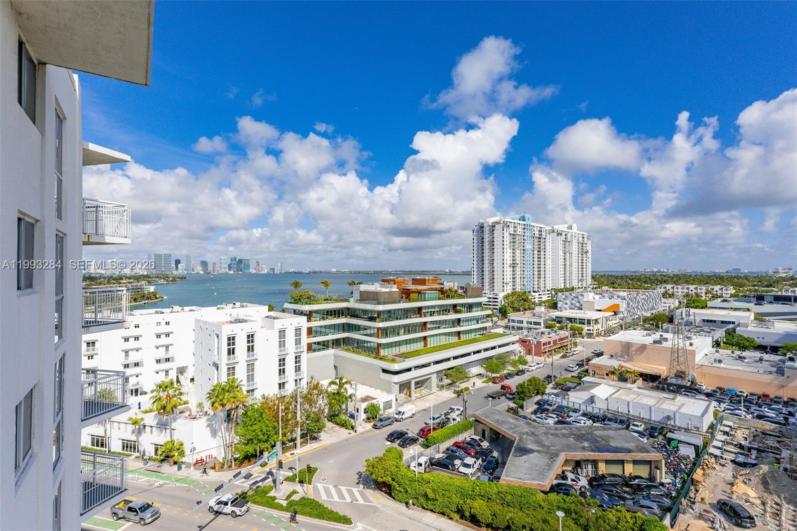 An elevated view shows a city street, modern buildings, and a bay under a blue sky — 1688 West Ave # 1205, Miami Beach FL 33139, MIAMI BEACH, FL