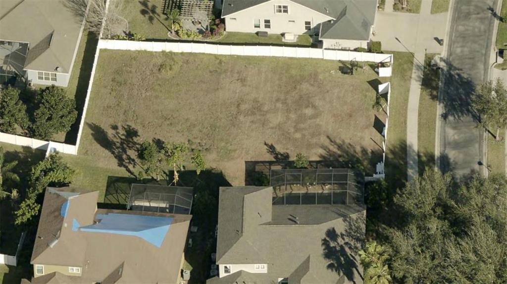 An aerial view shows a vacant, rectangular residential lot enclosed by a white vinyl fence — 3505 GRAYCLIFF LANE, BRANDON, FL