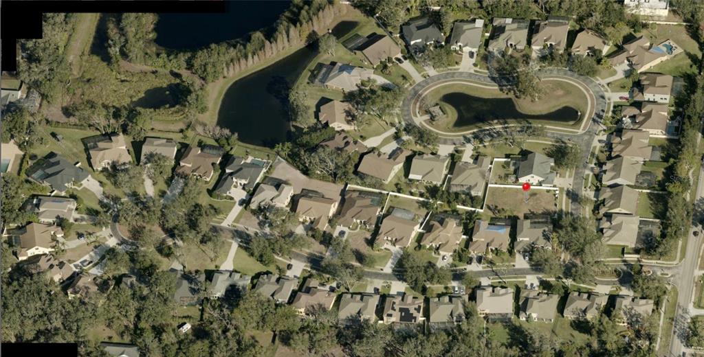 An aerial view shows a vacant residential lot marked with a red pin in a neighborhood — 3505 GRAYCLIFF LANE, BRANDON, FL
