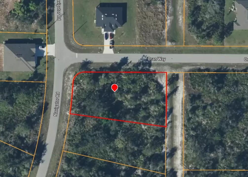 An aerial map view shows a vacant, wooded corner lot outlined in red — 1274 NAVIGATOR ROAD, PUNTA GORDA, FL