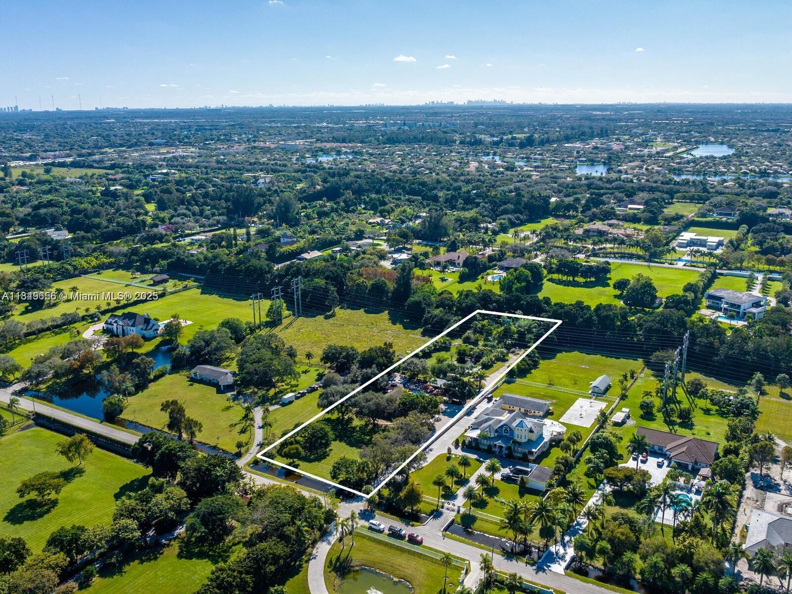An aerial view shows a rectangular property lot outlined in white within a suburban landscape — 13350 Luray Rd, Southwest Ranches FL 33330, SOUTHWEST RANCHES, FL