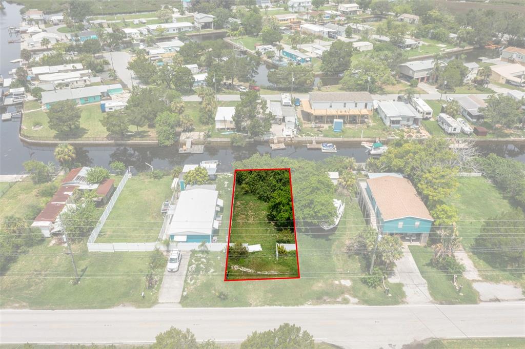 An aerial view shows a vacant rectangular lot outlined in red between two residential properties — 0 OLD DIXIE HIGHWAY, HUDSON, FL