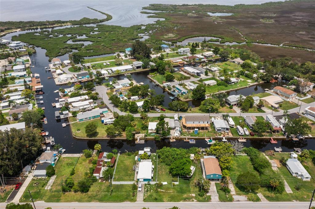 An aerial view of a waterfront residential neighborhood with canals, mobile homes, and marshland — 0 OLD DIXIE HIGHWAY, HUDSON, FL