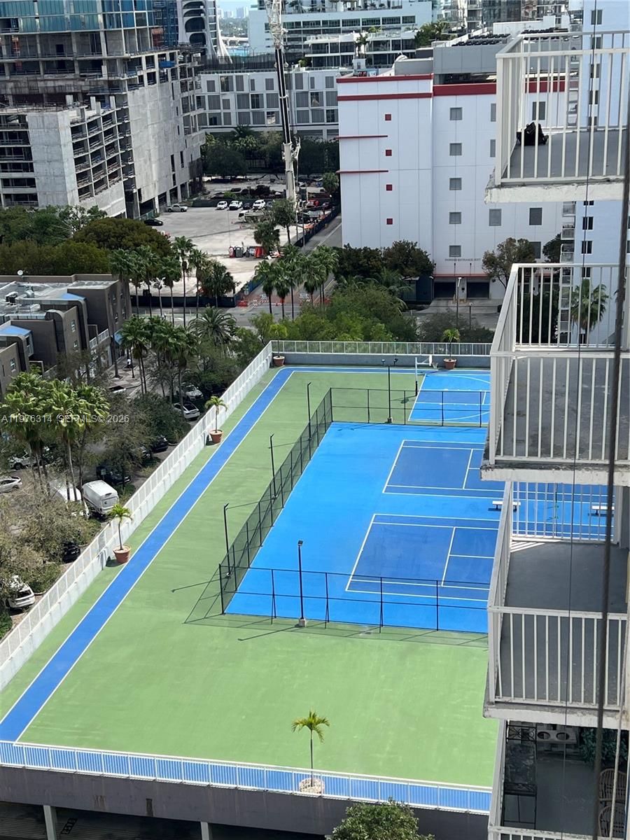 An elevated view shows a blue and green tennis court next to a residential building — 850 N Miami Ave # 1806, Miami FL 33136, MIAMI, FL