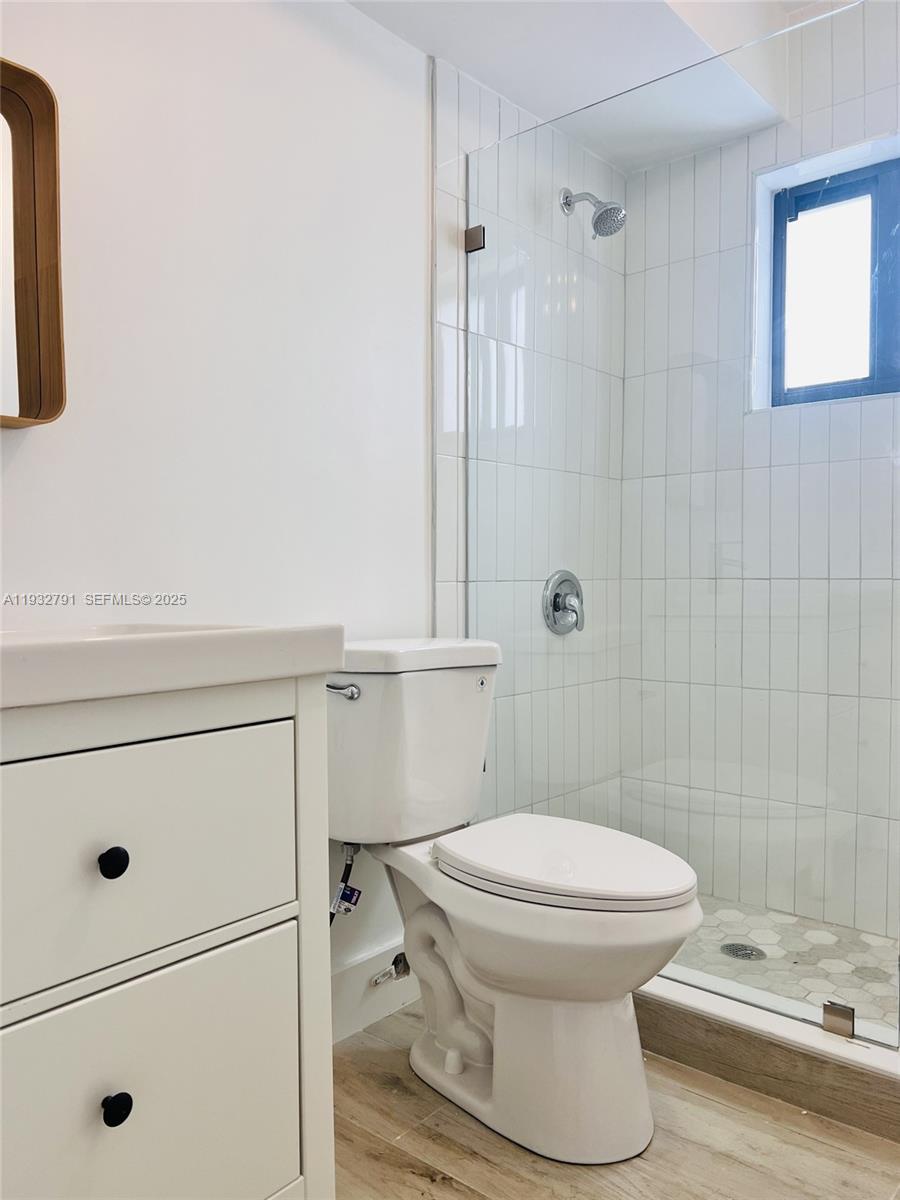 An empty room features white walls, dark baseboards, terrazzo flooring, and a glass balcony door — 910 SW 4th Ave # 3, Miami FL 33130, MIAMI, FL