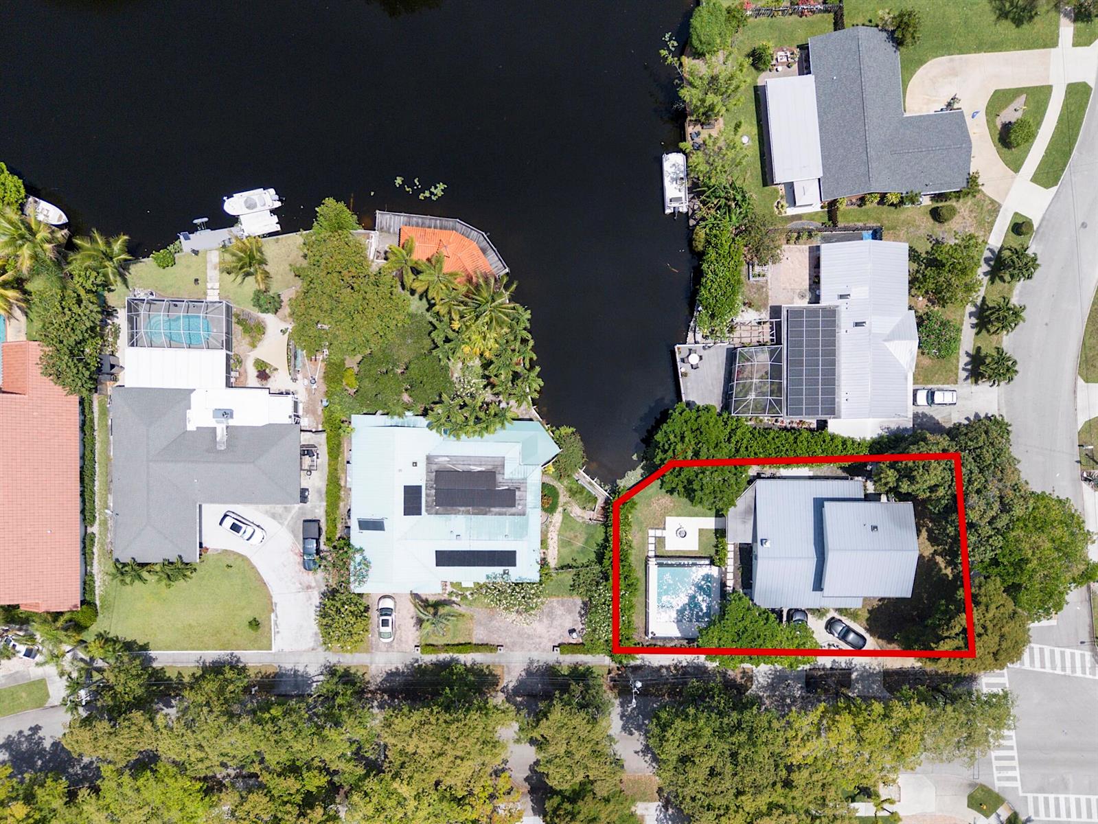 An aerial view shows a house with a pool and yard outlined in red — 1808 N 17th Ave Avenue N, FL 33460, FL