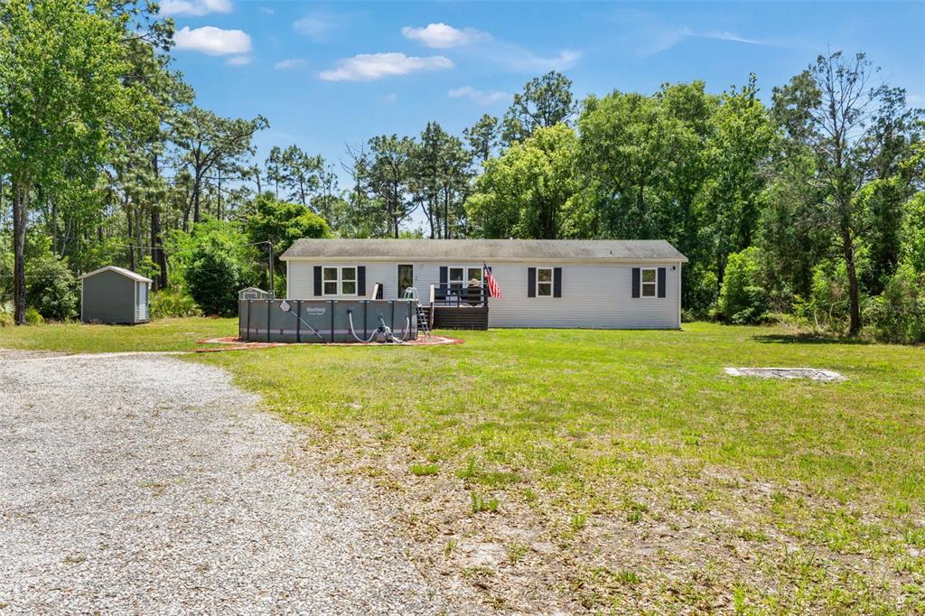 A single-story house with a pool and shed sits on a large, grassy lot — 6886 W EDGEWOOD LANE, HOMOSASSA, FL