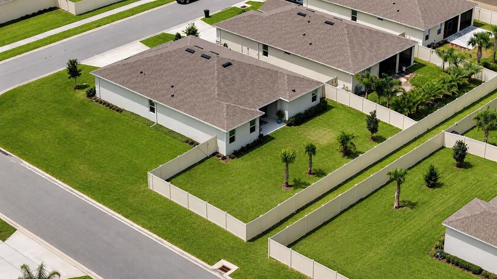 An aerial view shows a single-story house with a fenced backyard and palm trees — 349 ROVER ROAD, ORMOND BEACH, FL