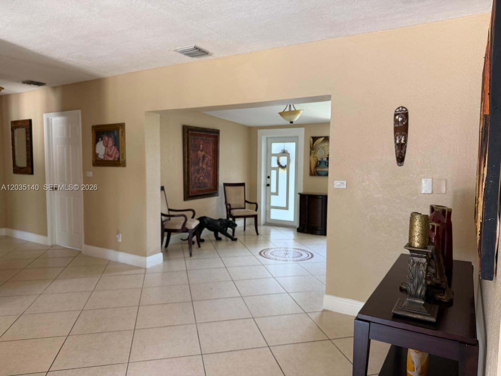 An interior view shows a tiled entryway leading to a doorway with a glass insert — 17405 SW 109th Ct, Miami FL 33157, MIAMI, FL