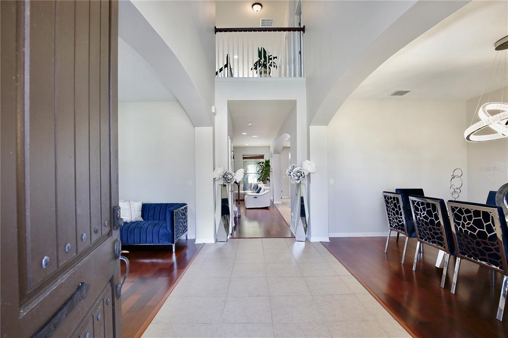 A view from an entryway into a home with tile flooring and hardwood accents — 450 TERRAVISTA PLACE, OVIEDO, FL