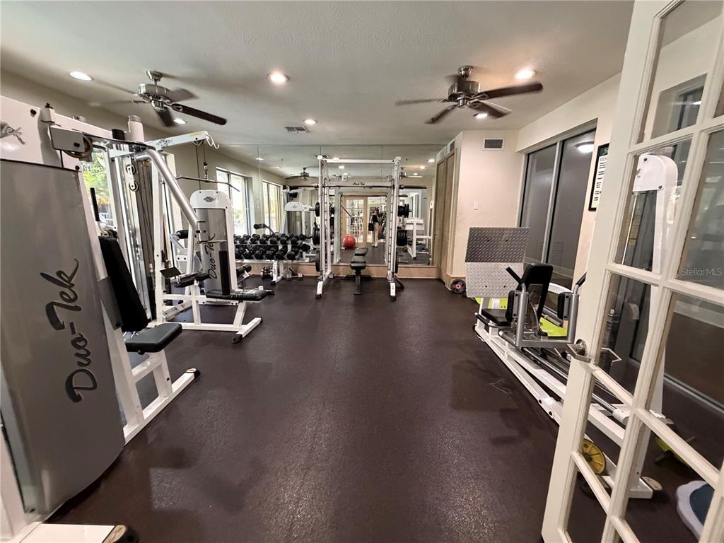 A spacious room features a pool table, two curved bar counters, and high ceilings — 860 N ORANGE AVENUE UNIT 379, ORLANDO, FL