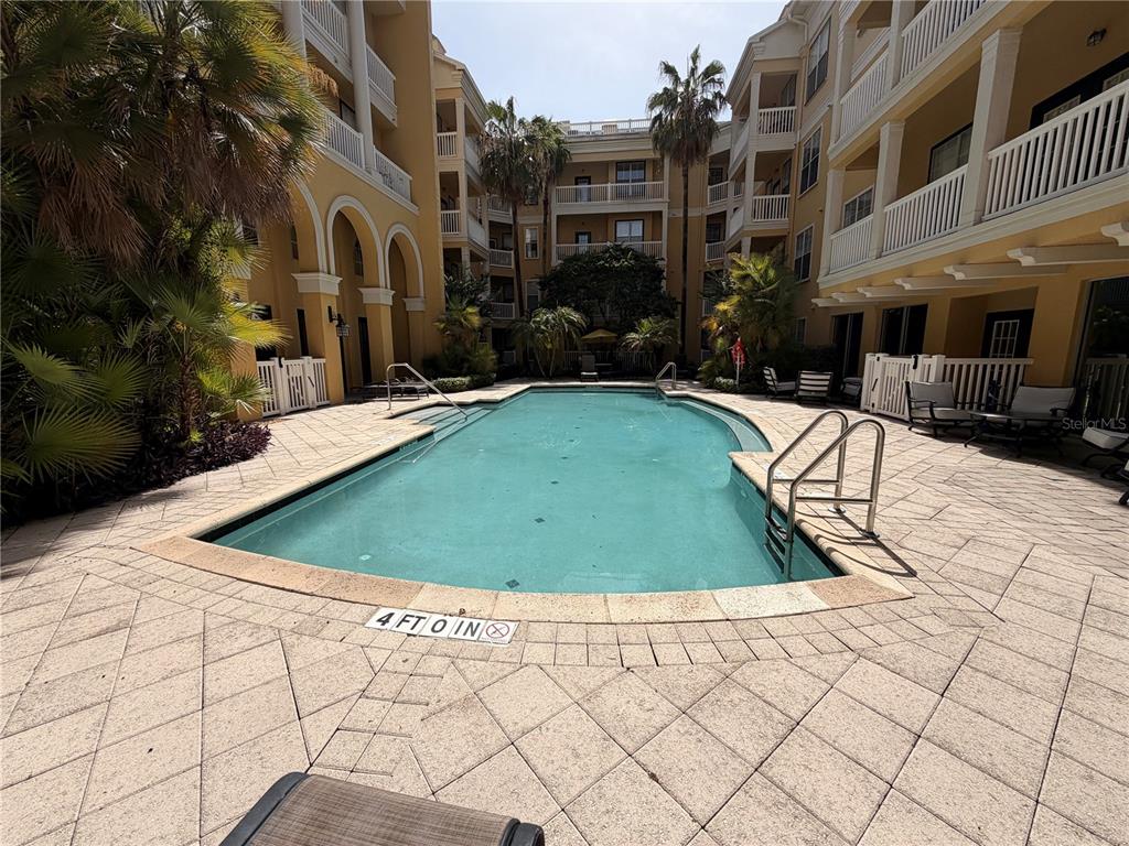 A gym room features several treadmills, an elliptical machine, a stationary bike, and mirrored walls — 860 N ORANGE AVENUE UNIT 379, ORLANDO, FL