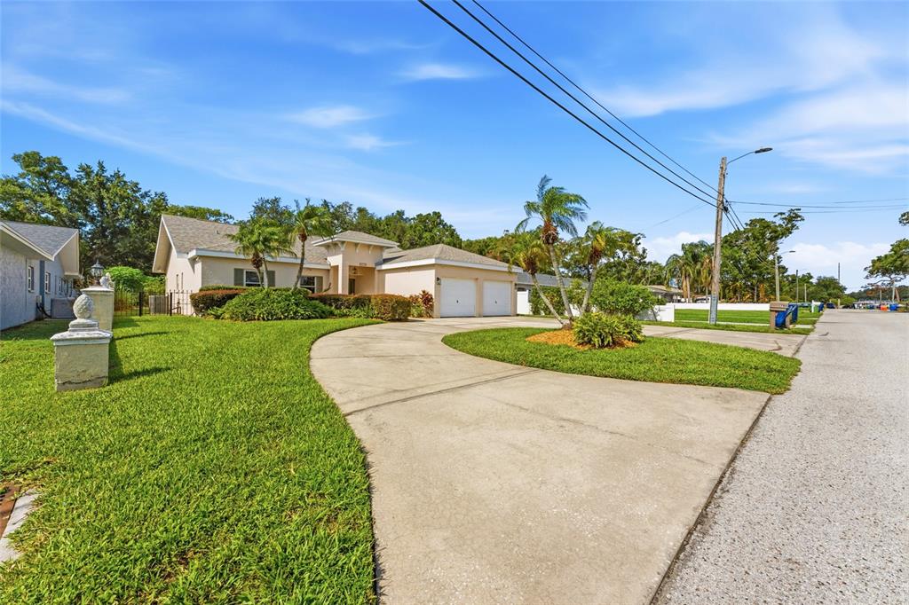 A single-story house with a two-car garage and a curved concrete driveway — 2708 W OSBORNE AVENUE, TAMPA, FL