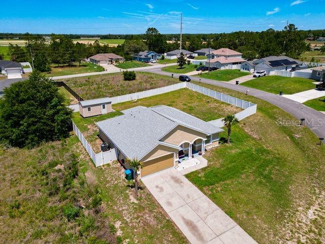 An aerial view shows a single-story house with a fenced yard and a detached shed — 13338 SW 48TH AVENUE, OCALA, FL