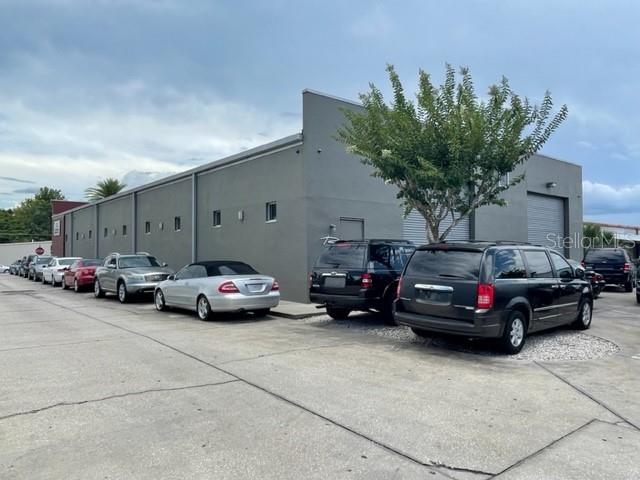 A gray commercial building features a parking lot filled with several parked vehicles — 145 RONNING WAY, LONGWOOD, FL