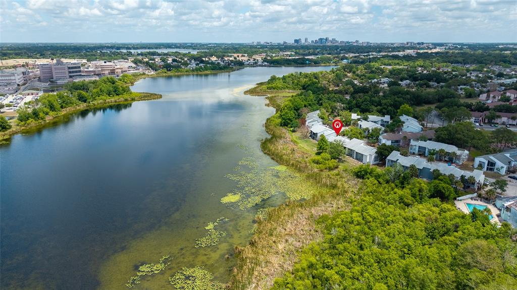 An aerial view shows a lakefront apartment complex with a red location marker — 4340 AQUA VISTA DRIVE UNIT A, ORLANDO, FL
