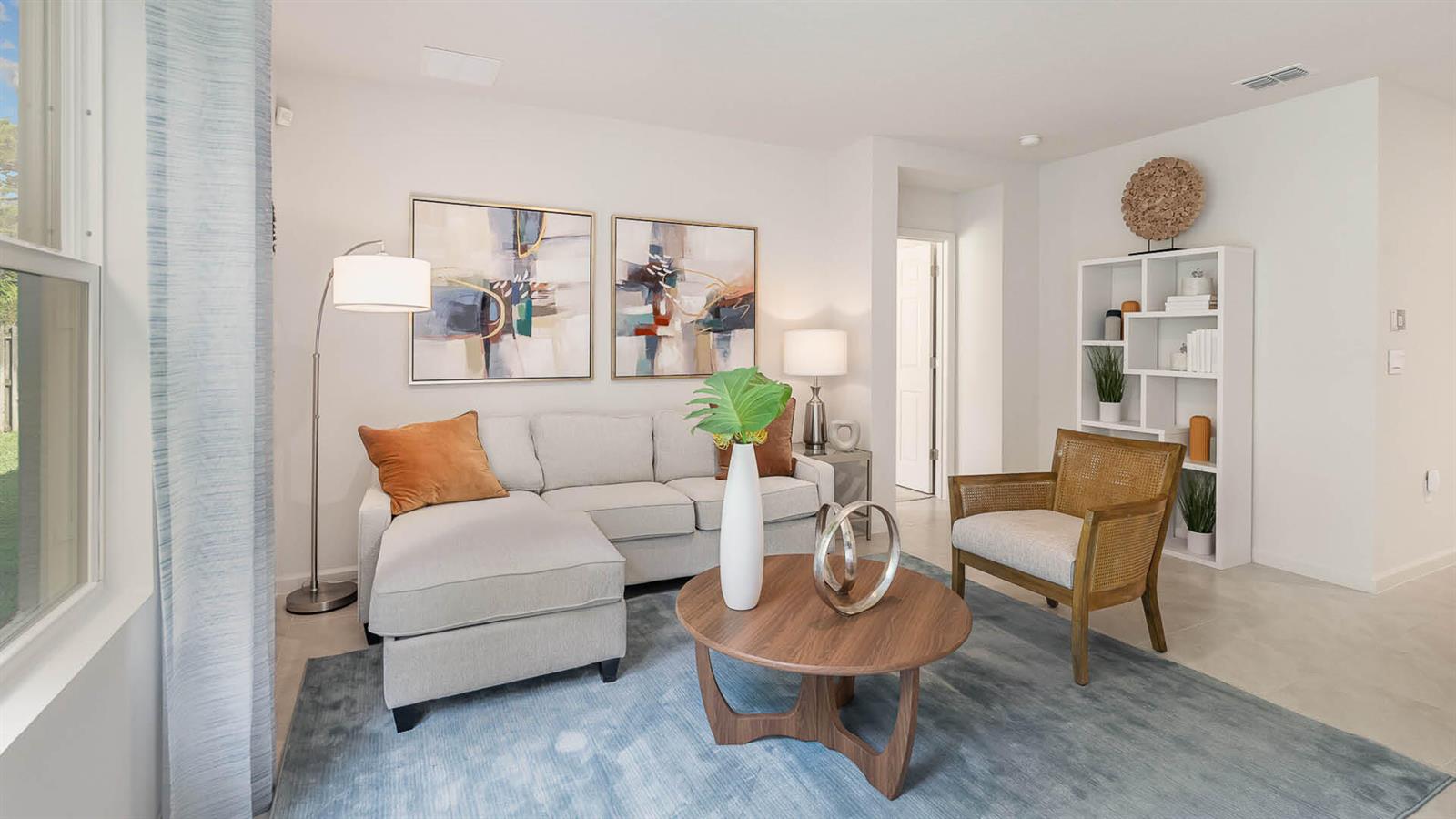 A living room features a sectional sofa, a round wooden coffee table, and an armchair — 2813 NW 4th Street, Okeechobee FL 34972, OKEECHOBEE, FL