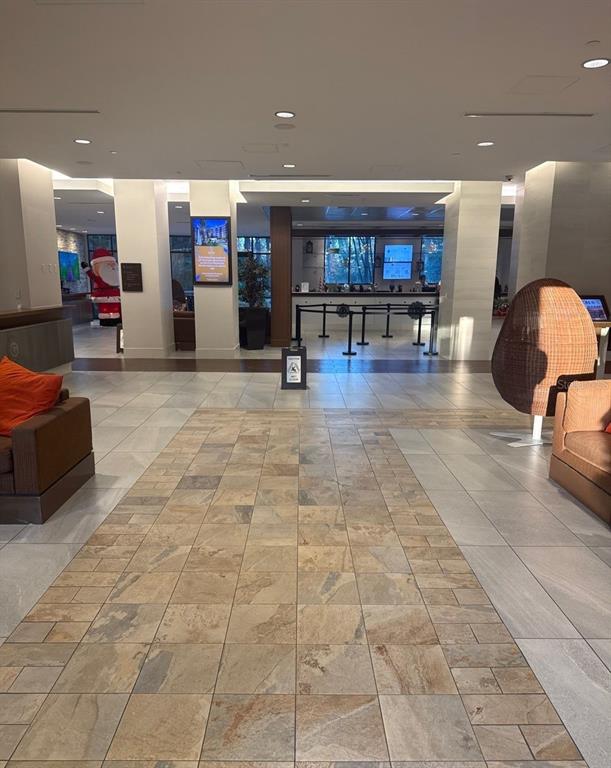 A hotel lobby features tiled flooring, seating areas, a reception desk, and a Santa decoration — 14501 GROVE RESORT AVENUE UNIT 2616, WINTER GARDEN, FL
