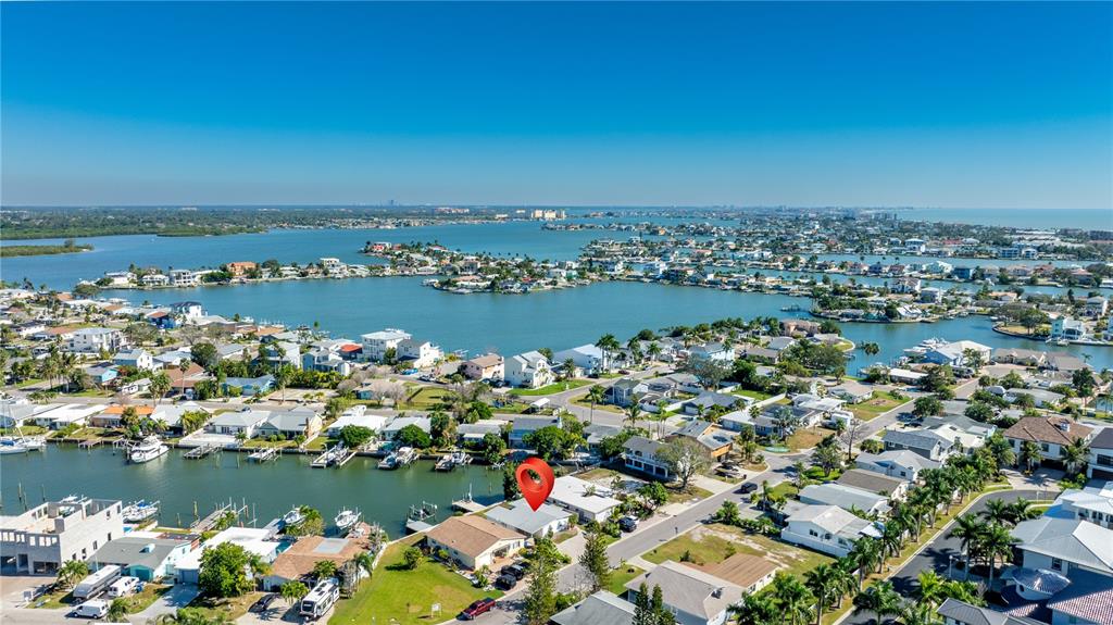 This aerial view shows a coastal neighborhood with a red location pin on a house — 17611 1ST STREET E, REDINGTON SHORES, FL