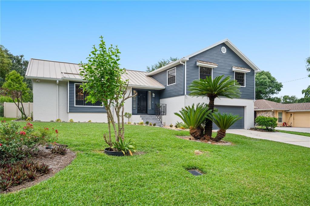 A two-story house with blue siding, a white lower level, and a two-car garage — 3829 ERIC COURT, LAKELAND, FL