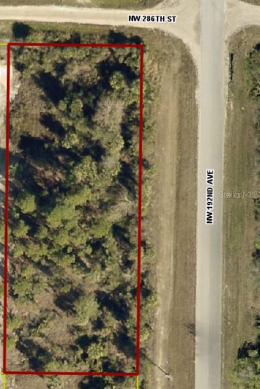 An aerial view shows a rectangular, wooded vacant lot outlined in red next to roads — 19218 NW 286TH STREET, OKEECHOBEE, FL