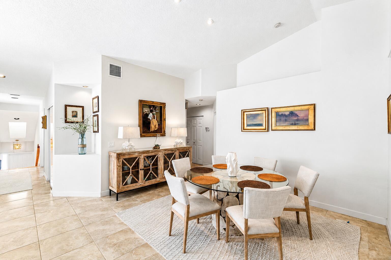 A dining room features a glass-topped table, six upholstered chairs, and a wooden sideboard — 17061 Emile Street # 5, Boca Raton FL 33487, BOCA RATON, FL
