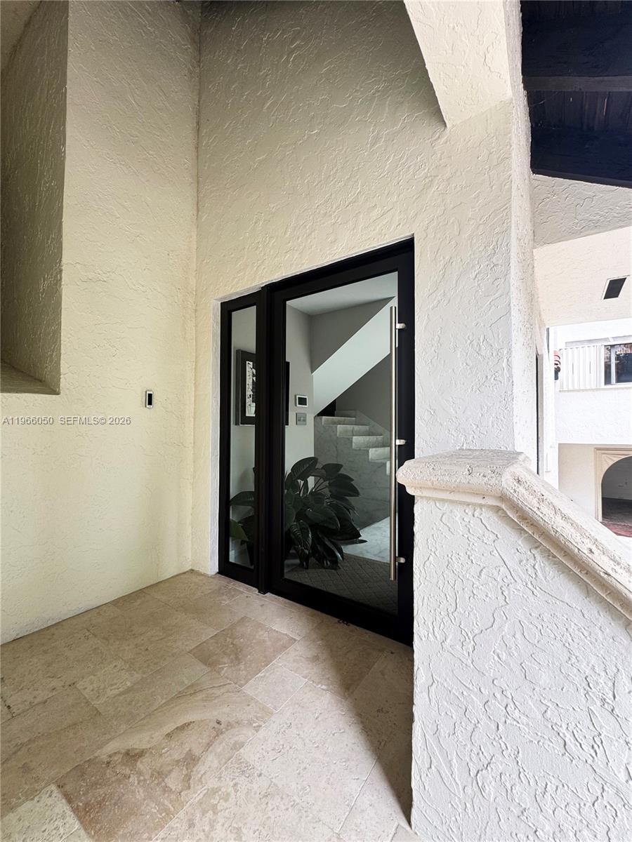 A modern glass front door with a side light opens into a tiled entryway — 2000 S Bayshore Drive # 13, Miami FL 33133, MIAMI, FL