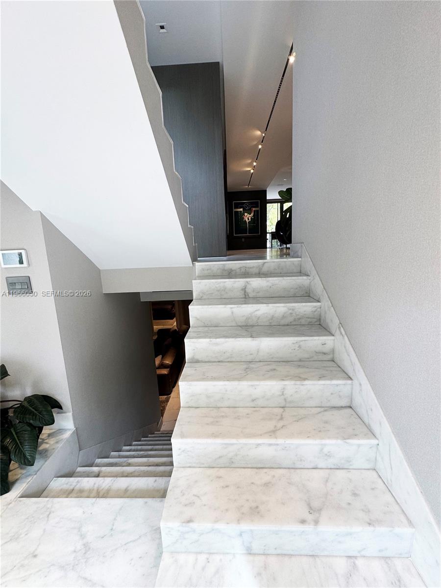 A marble staircase leads upward in a modern interior with gray walls and recessed lighting — 2000 S Bayshore Drive # 13, Miami FL 33133, MIAMI, FL