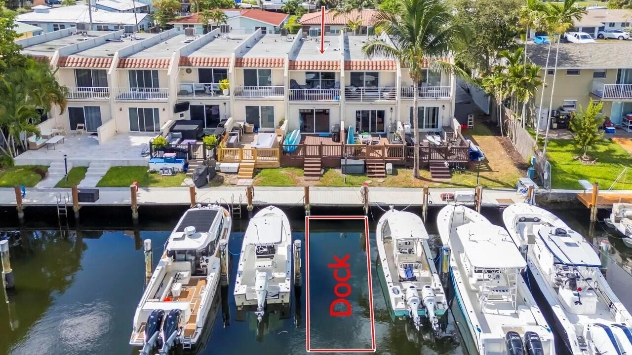 An aerial view shows a row of townhouses with private boat slips along a canal — 1839 SE 4th Street, Pompano Beach FL 33060, POMPANO BEACH, FL