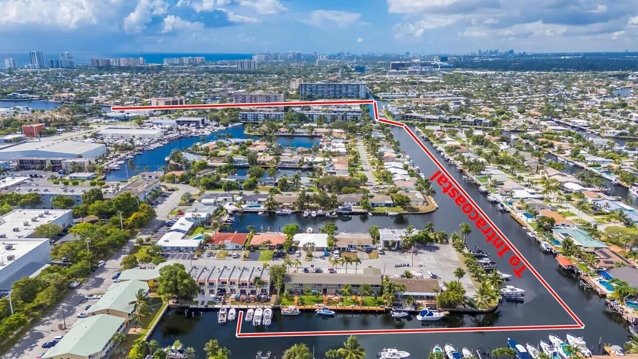 An aerial view shows a waterfront apartment complex with boat docks and surrounding residential neighborhoods — 1839 SE 4th Street, Pompano Beach FL 33060, POMPANO BEACH, FL
