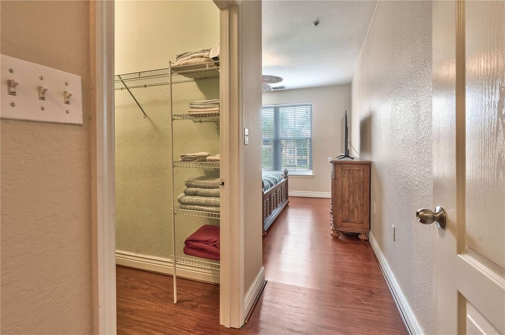A view from a doorway looking into a bedroom with wood-look flooring and a closet — 2732 VIA MURANO UNIT 526, CLEARWATER, FL