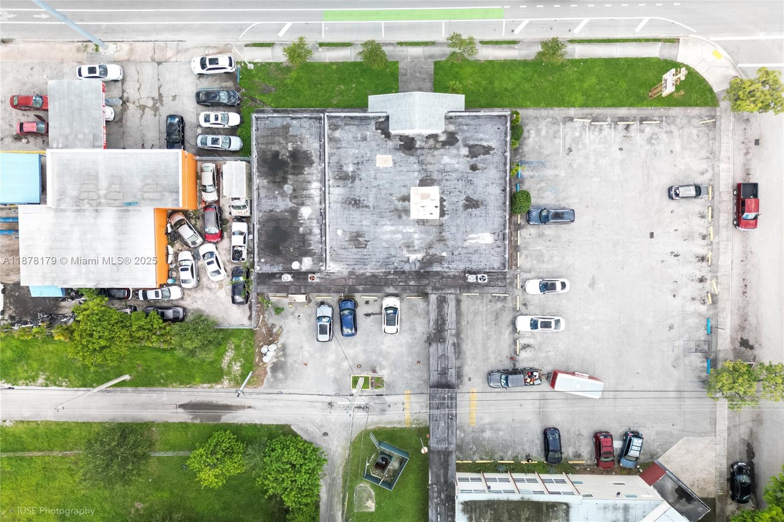 An aerial view shows a commercial building with a large parking lot and surrounding grounds — 13242 NW 7th Ave, North Miami FL 33168, NORTH MIAMI, FL