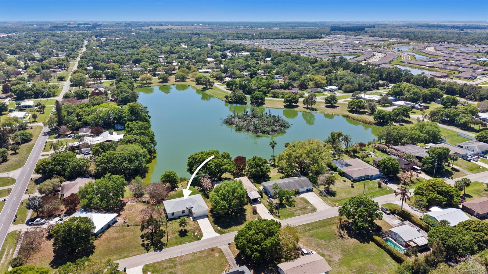 An aerial view shows a single-story house with a white arrow pointing to its roof — 7705 Sebastian Road, Fort Pierce FL 34951, FORT PIERCE, FL