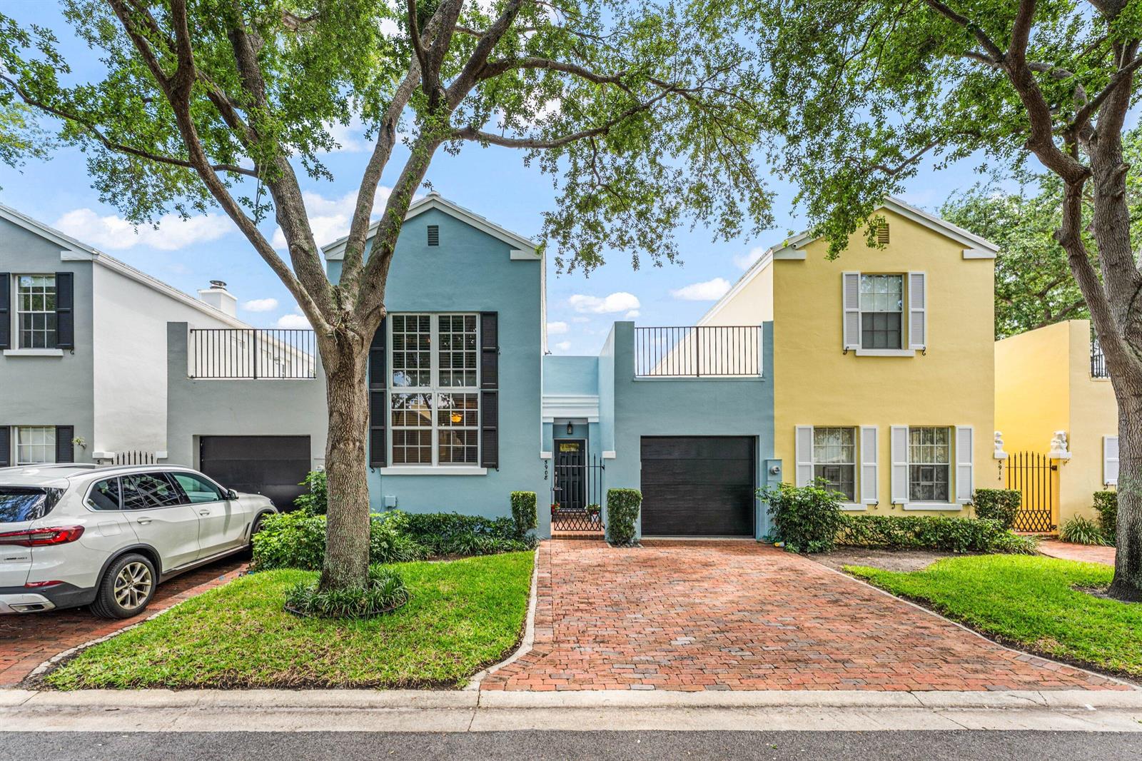 A light blue and yellow two-story townhouse with a brick driveway and a white SUV — 5908 Catesby Street, Boca Raton FL 33433, BOCA RATON, FL