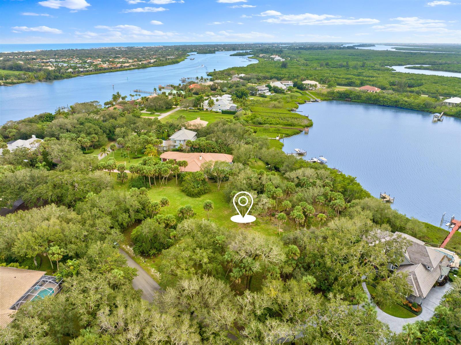 An aerial view shows a wooded residential lot with a location pin near water — 2545 Riverview Court, Vero Beach FL 32963, VERO BEACH, FL