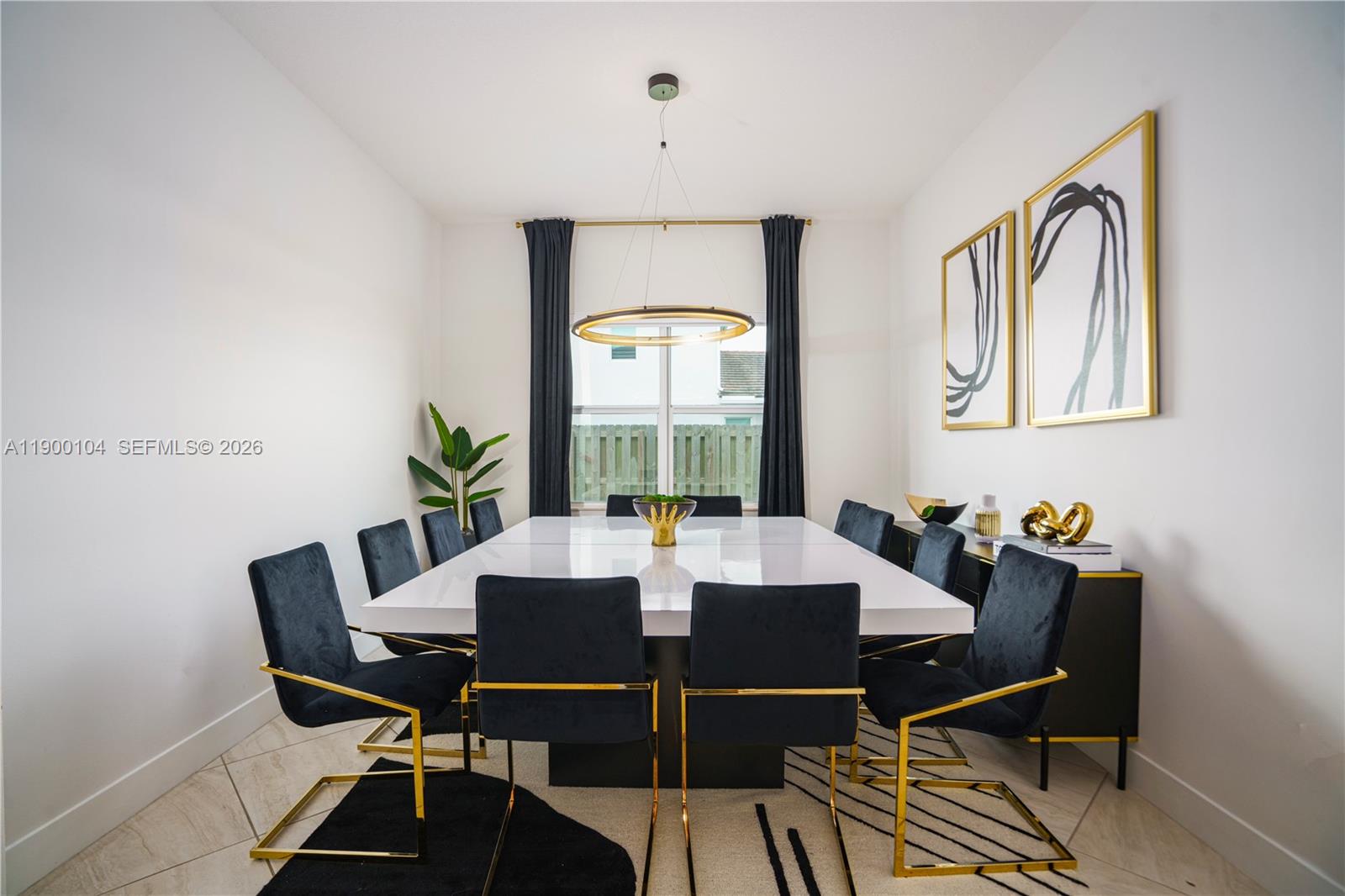 A dining room features a white table, black velvet chairs, and a gold circular chandelier — 11 NW 122nd Ave, Miami FL 33182, MIAMI, FL